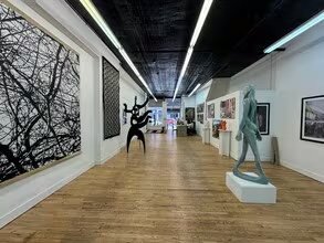 Former gallery interior showing white walls and display floor